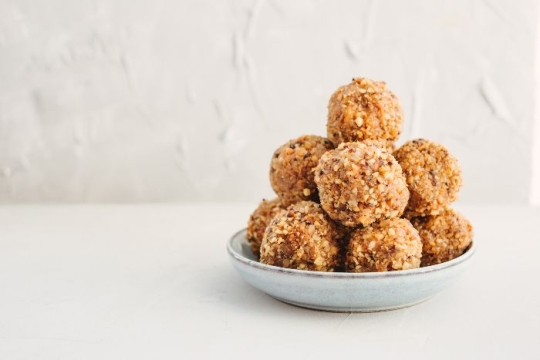 Small bowl stacked with peanut butter balls